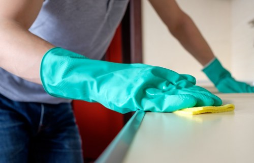 Local cleaner preparing bedding and living spaces for Airbnb guests